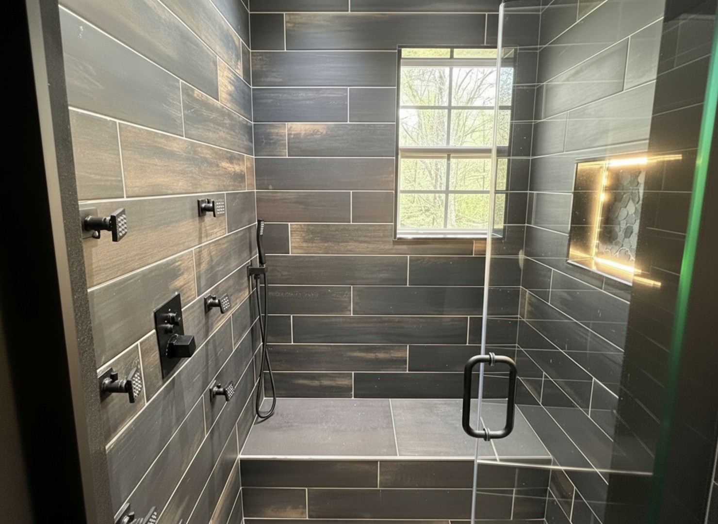 Indulge in a rejuvenating shower experience with multiple spray options and a built-in bench, all while enjoying tranquil views of nature.