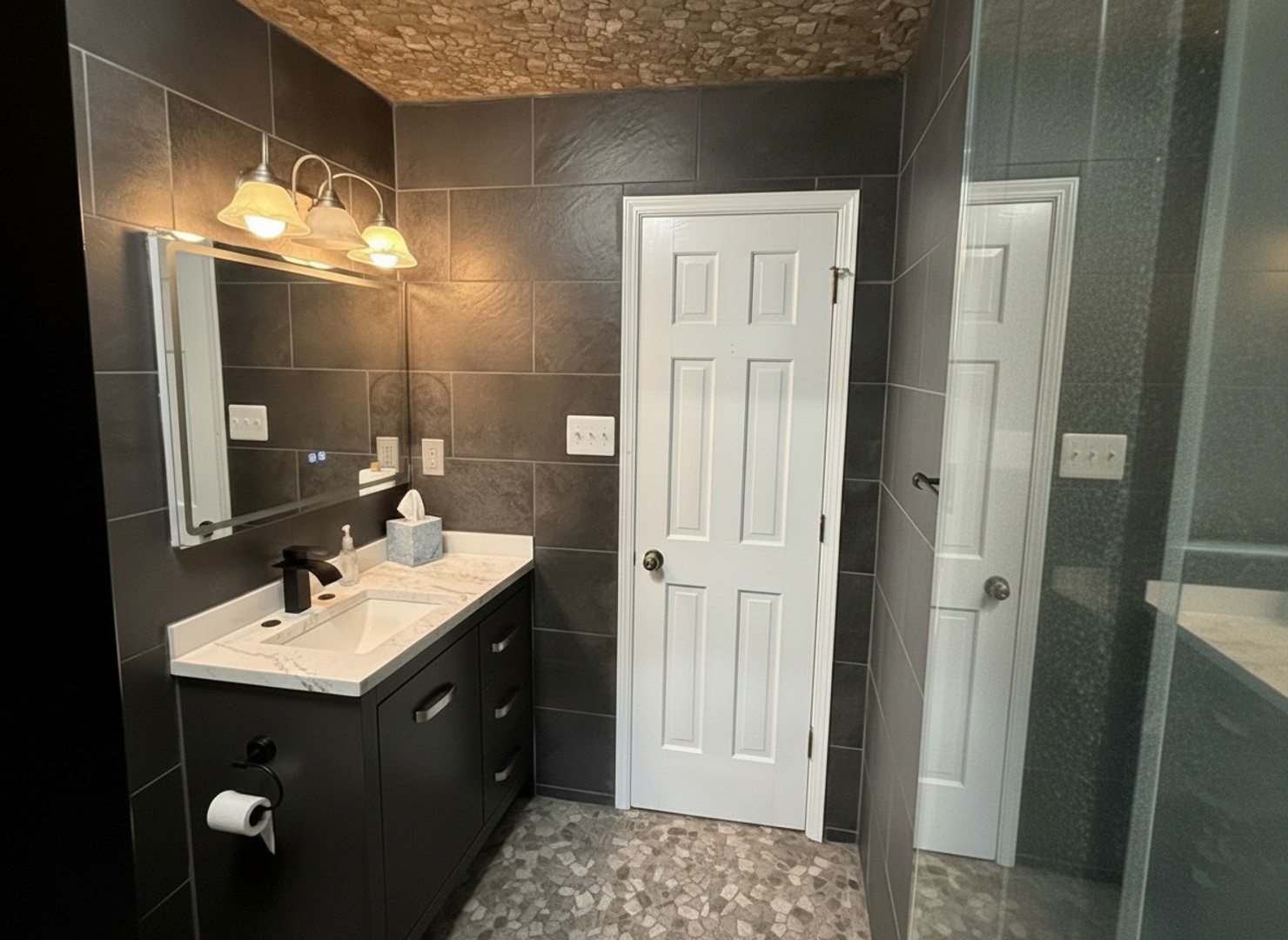 Freshen up at the elegant vanity before stepping into the spacious shower to start your day.