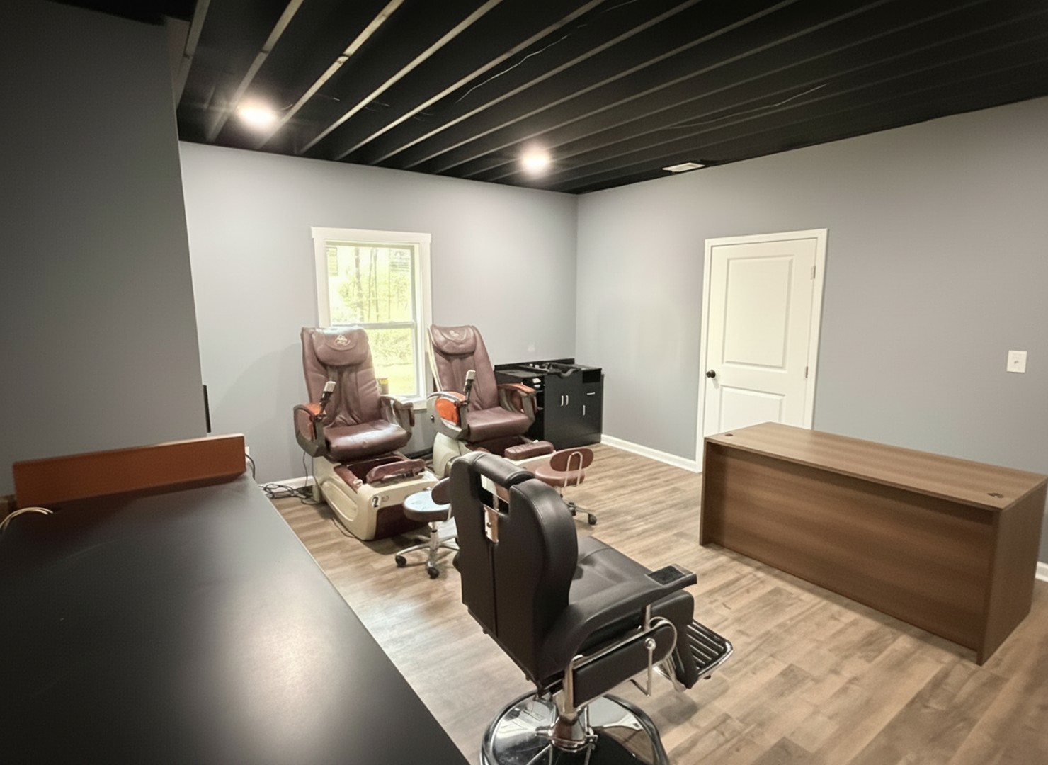 Indulge in a pampering session right here, enjoying the comfort of these salon chairs and a quiet moment by the window.